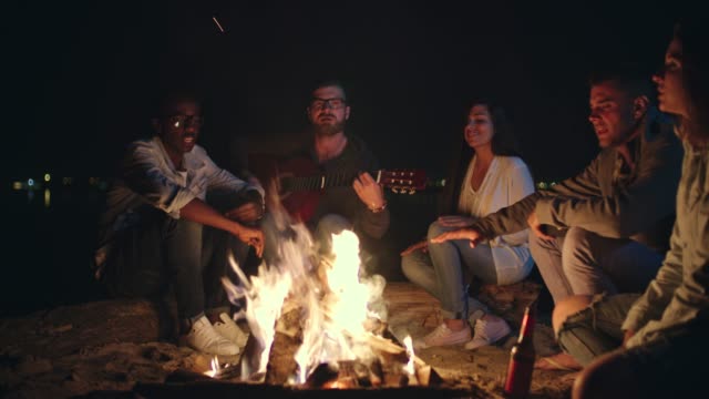 Group-of-Friends-Singing-by-Campfire