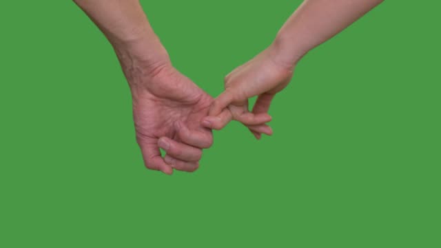 Male-hand-holding-female-hand-on-little-finger-on-green-background-close-up-Alpha-channel,-keyed-green-screen