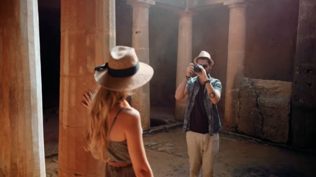 Tourists-couple-with-camera-taking-photos-at-European-archaeological-site