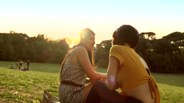 laughter-and-talk-among-women-at-sunset--friends-laugh-and-joke-at-the-park