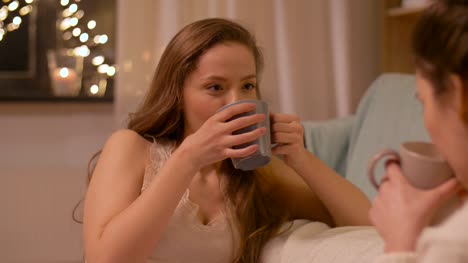 woman-drinking-tea-and-talking-to-friend-at-home