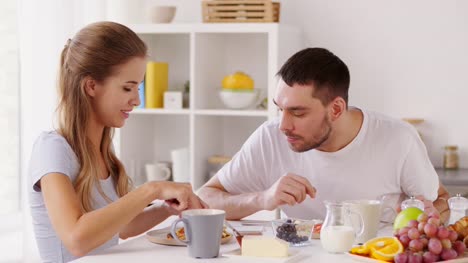 happy-couple-having-breakfast-at-home