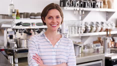 Young-woman-behind-the-counter-at-a-coffee-shop,-close-up