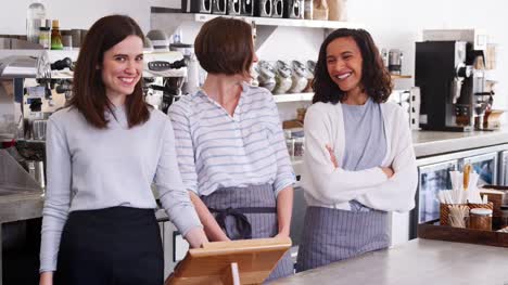 Female-business-partners-behind-the-counter-at-their-cafe