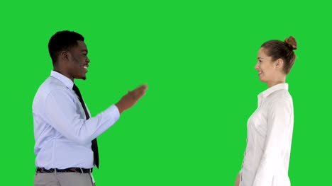 Young-woman-and-young-man-in-formal-clothes-give-high-five-on-a-Green-Screen,-Chroma-Key