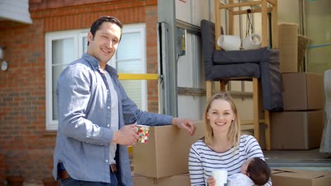 Portrait-Of-Family-On-Tail-Lift-Of-Removal-Truck-Moving-Home
