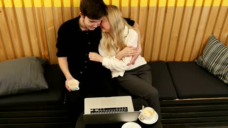 Loving-couple-sitting-in-drinking-coffee-enjoying-time-together