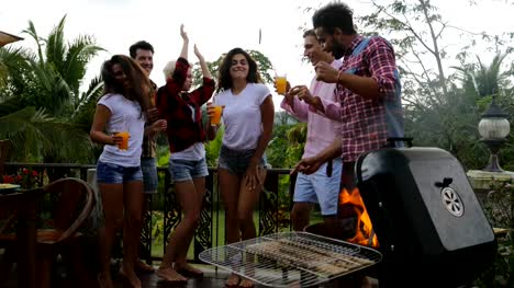 Young-People-Dancing-While-Cooking-Barbecue-Happy-Group-Cheerful-Gathering-On-Summer-Terrace-Having-Party