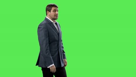 Media-reporter-is-talking-about-weather-on-a-mock-up-green-screen-in-the-background.