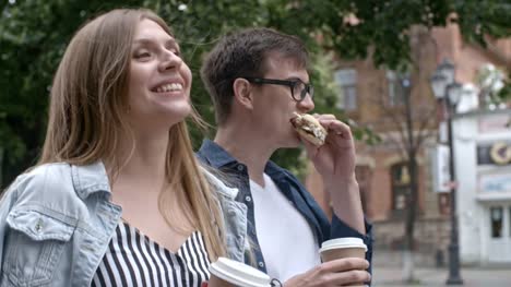 Boyfriend-and-Girlfriend-Walking-with-Coffee-and-Sandwich