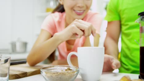 Male-female-Ethnic-couple-kitchen-counter-breakfast-coffee