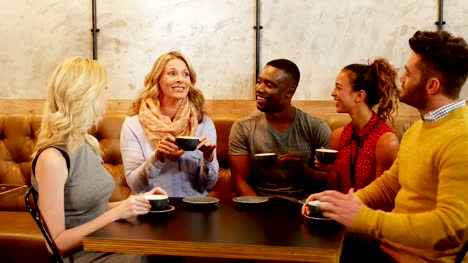 Group-of-happy-friends-interacting-while-having-coffee-4K-4k