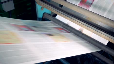 Printing-house-equipment.-Printing-machine-with-huge-amount-of-newspapers.