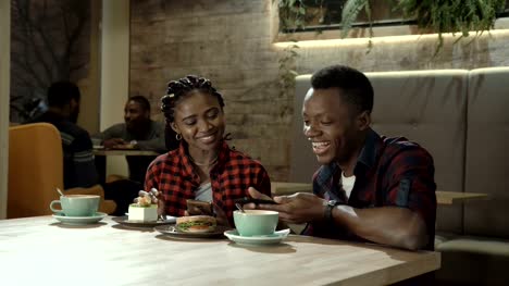 Young-Black-couple-eating-refreshments-at-a-cafe