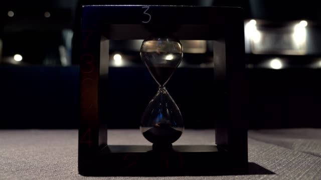 Hourglass-in-dark.time,-inexorable,-past