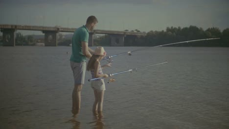 Father-and-daughter-enjoying-fishing-together