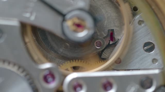 mechanical-watch-with-focus-on-gear-with-ruby-on-background