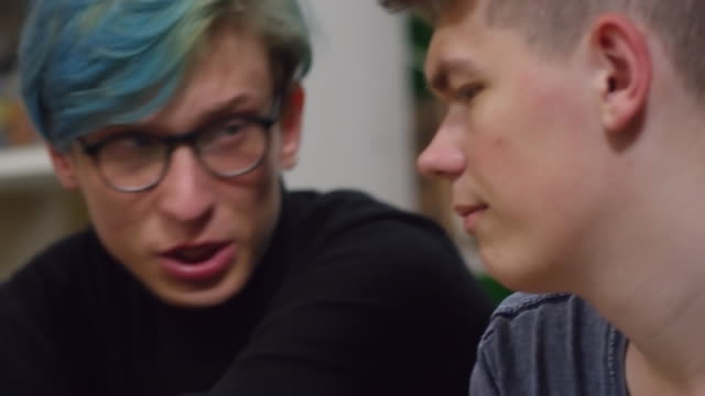 Young-Man-in-Glasses-Talking-to-Friend