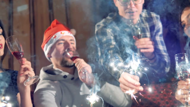 A-close-up-shot-on-people-celebrating-Christmas-with-wine-and-sparklers.