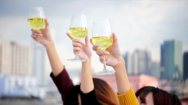 Outdoor-shot-of-young-people-toasting-drinks-at-a-rooftop-party.-Young-asian-girl-friends-hanging-out-with-drinks.-Holiday-celebration-festive-party.-Teenage-lifestyle-party.-Freedom-and-fun-outdoor.