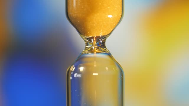 Hourglass.-Super-Close-up-View-of-Sand-Flowing-Through-an-Hourglass