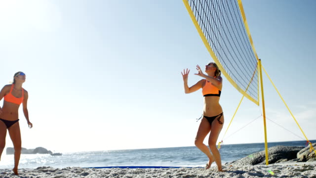 Female-volleyball-players-playing-volleyball-4k