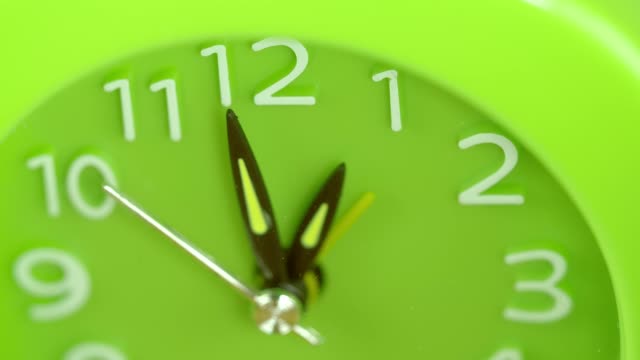close-up-hands-running-on-green-clock--Time,symbol,hurry