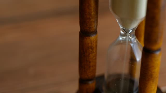 Close-up-View-of-Sand-in-hourglass-or-sandglass-for-time-counting-down.-for-loop-or-repeat-pattern.