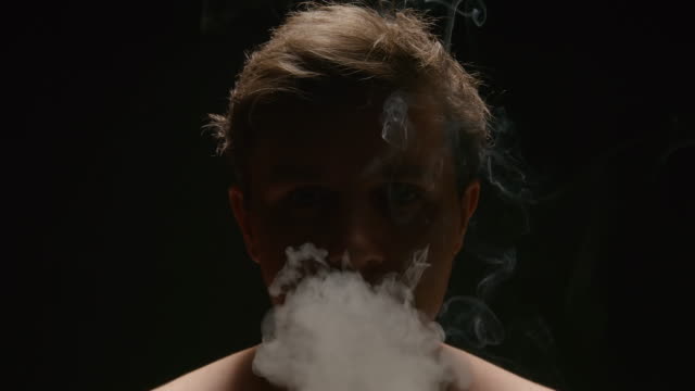 SLOW-MOTION:-Smoker-exhales-out-a-smoke