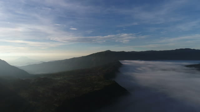 Aerial-view-flight-over-Cemoro-Lawang,-small-village-in-morning-mist