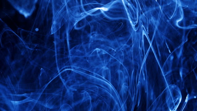 Shot-of-Ink-Moves.-Cosmic-abstraction-of-a-light-blue-particle-ink.-macro