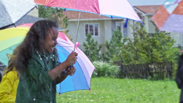Niños-felices-con-paraguas-bajo-la-lluvia