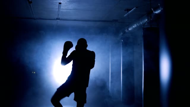 Boxer-workout-in-a-boxing-club.-Silhouette