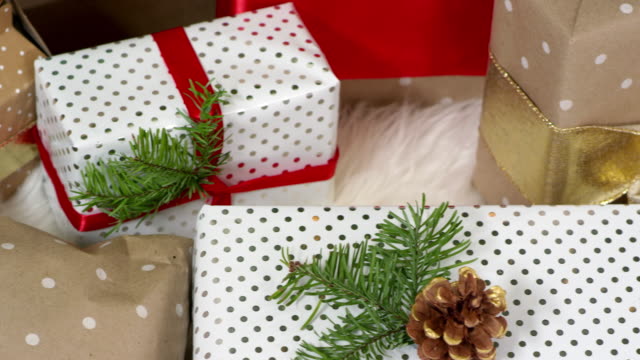 Close-up-pan-of-presents-sitting-under-the-tree-on-christmas-morning