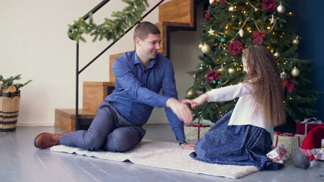 Joyful-daughter-giving-a-christmas-gift-to-father