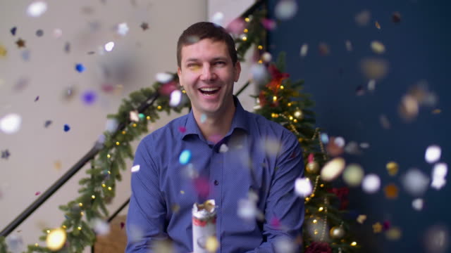 Ecstatic-man-exploding-christmas-confetti-cracker