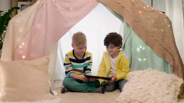 little-boys-with-tablet-pc-in-kids-tent-at-home