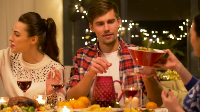 friends-eating-at-home-christmas-dinner-party