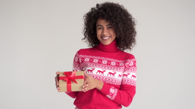 Happy-woman-holding-Christmas-gift