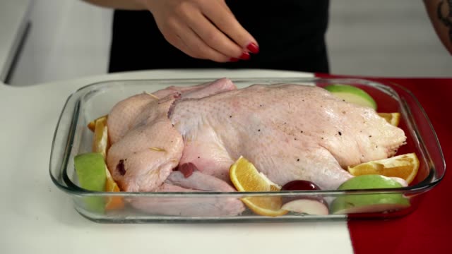 Woman-Preparing-stuffed-duck-for-christmas-dinner