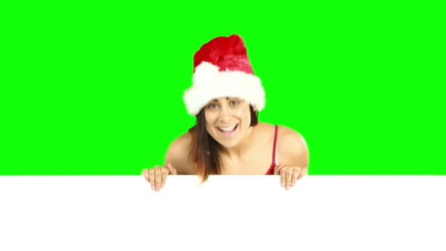 Beauty-brunette-in-santa-hat-showing-white-poster