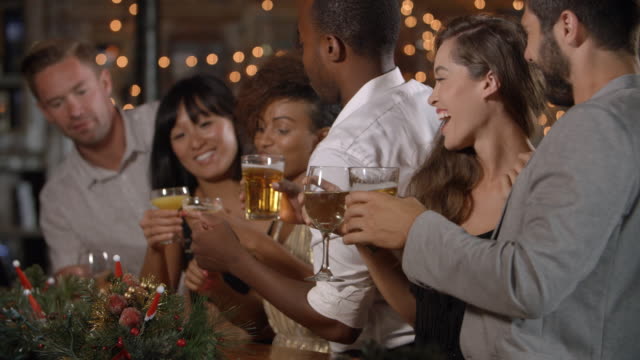 Freunde-feiern-gemeinsam-bei-einer-Weihnachtsfeier-in-einer-Bar