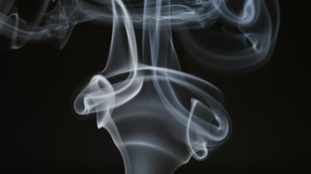 SLOW-MOTION:-Curly-line-of-smoke-on-a-dark-background