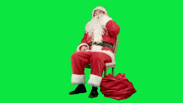 Santa-claus-calling-by-mobile-cell-phone-on-a-Green-Screen-Chrome-Key