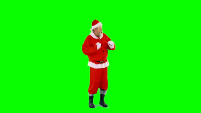 Santa-Claus-tanzen-vor-grünem-Hintergrund