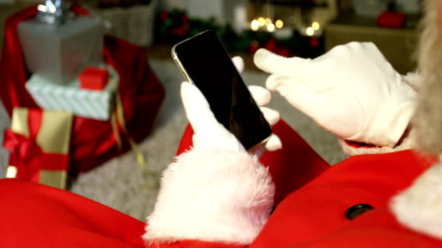 Close-up-of-santa-claus-using-mobile-phone