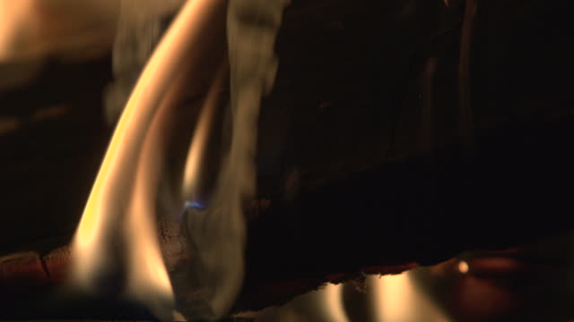 Closeup-shot-of-a-flame-and-smoke-burning-wood