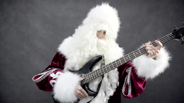 Santa-claus-plays-of-the-christmas-melody-jingle-bells-on-the-bass-guitar