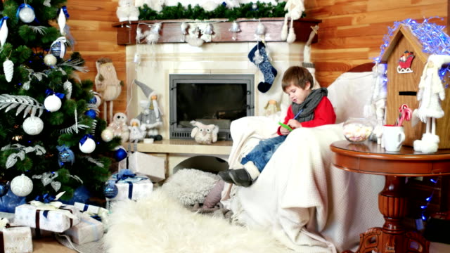 little-boy-writing-letter-to-santa,-holiday-atmosphere,-santa-claus-mail-center,-room-with-fireplace