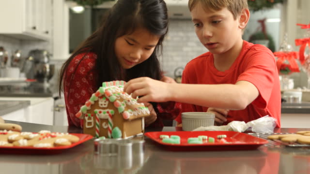 Decorating-gingerbread-house-for-Christmas